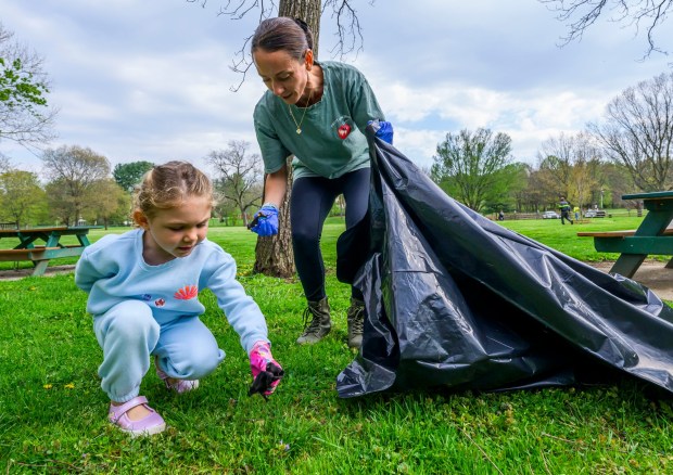 Mother Brittany Waterhouse and daughter Grace, 5, both of Schnecksville pick up litter along the park Wednesday, April 22, 2026, in celebration of Earth Day during Plant for Spring! hosted by South Whitehall Township Parks and Recreation at Covered Bridge Park Playground in South Whitehall Township (April Gamiz/The Morning Call)
