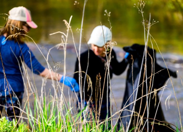 Mother Emily Lenneville and daughter Anna, 10, both of South Whitehall Township pick up litter along the park Wednesday, April 22, 2026, in celebration of Earth Day during Plant for Spring! hosted by South Whitehall Township Parks and Recreation at Covered Bridge Park Playground in South Whitehall Township (April Gamiz/The Morning Call)