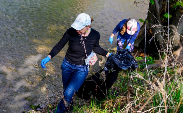 Mother Emily Lenneville and daughter Anna, 10, both of South Whitehall Township pick up litter along the park Wednesday, April 22, 2026, in celebration of Earth Day during Plant for Spring! hosted by South Whitehall Township Parks and Recreation at Covered Bridge Park Playground in South Whitehall Township (April Gamiz/The Morning Call)