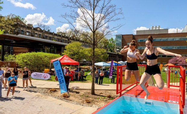 Lehigh University students Sophia Bond and Belle Bramer jump together into cold water Friday, April 17, 2026, during Special Olympics Pennsylvania's Mobile Polar Plunge at Lehigh University in Bethlehem. More than 100 Lehigh students and staff jumped into the water to raise money and awareness for athletes with intellectual and developmental disabilities. (April Gamiz/The Morning Call)