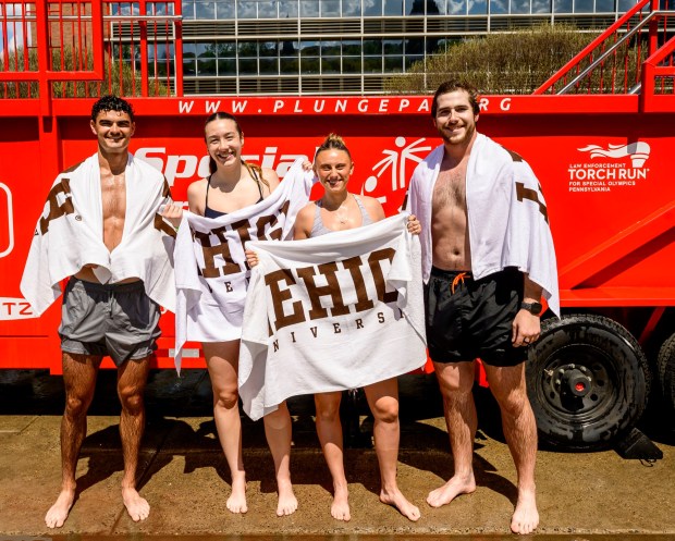 Lehigh University students John Deutsch, Belle Bramer, Sophia Bond and Jake Stalsitz pose for photos after taking the plunge Friday, April 17, 2026, during Special Olympics Pennsylvania's Mobile Polar Plunge at Lehigh University in Bethlehem. More than 100 Lehigh students and staff jumped into the water to raise money and awareness for athletes with intellectual and developmental disabilities. (April Gamiz/The Morning Call)