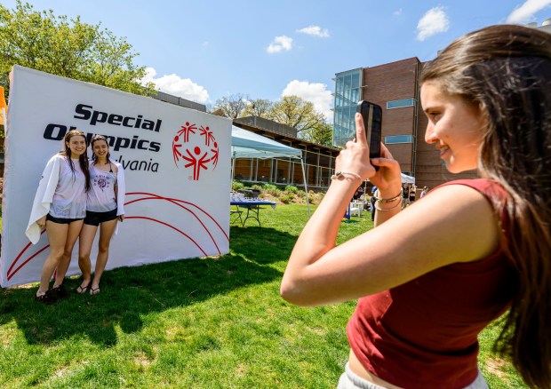 Lehigh University students Marianna Angle. Gabbi Weiss and Lauren Solorzano take photos after taking the plunge Friday, April 17, 2026, during Special Olympics Pennsylvania's Mobile Polar Plunge at Lehigh University in Bethlehem. More than 100 Lehigh students and staff jumped into the water to raise money and awareness for athletes with intellectual and developmental disabilities. (April Gamiz/The Morning Call)