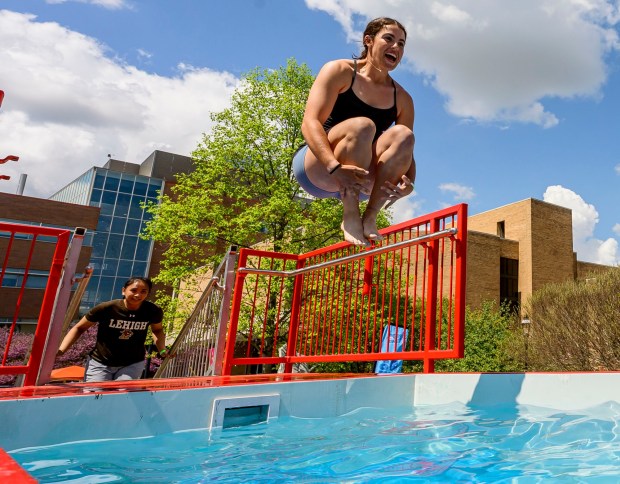 Lehigh University student Kelly Fricker jumps into cold water Friday, April 17, 2026, during Special Olympics Pennsylvania's Mobile Polar Plunge at Lehigh University in Bethlehem. More than 100 Lehigh students and staff jumped into the water to raise money and awareness for athletes with intellectual and developmental disabilities. (April Gamiz/The Morning Call)