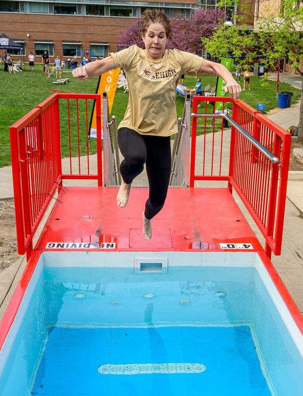 Lehigh University's Ashley Lemmons, assistant vice president and dean for student life and leadership, takes the plunge Friday, April 17, 2026, during Special Olympics Pennsylvania's Mobile Polar Plunge at Lehigh University in Bethlehem. More than 100 Lehigh students and staff jumped into the water to raise money and awareness for athletes with intellectual and developmental disabilities. (April Gamiz/The Morning Call)