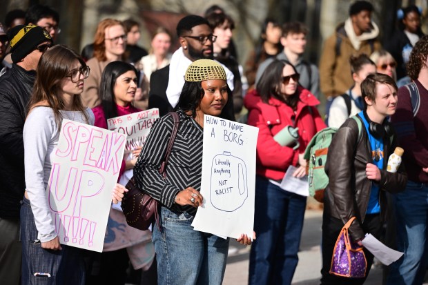 Lehigh University senior Kira Miller holds a sign with an empty plastic jug, known as a BORG, drawn on it Monday, April 6, 2026, during a public demonstration against racism at the university in Bethlehem. Students say racist messages were found drawn on two bottles found on or near the campus in recent months, and they were calling on leadership to address it. (Monica Cabrera/The Morning Call)