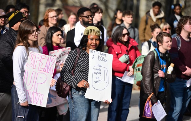 Lehigh University senior Kira Miller holds a sign with an empty plastic jug, known as a BORG, drawn on it Monday, April 6, 2026, during a public demonstration against racism at the university in Bethlehem. Students say racist messages were found drawn on two bottles found on or near the campus in recent months, and they were calling on leadership to address it. (Monica Cabrera/The Morning Call)