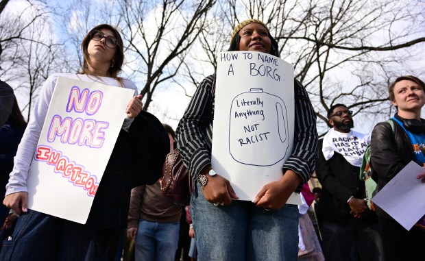 Lehigh University senior Kira Miller holds a sign with an empty plastic jug, known as a BORG, drawn on it Monday, April 6, 2026, during a public demonstration against racism at the university in Bethlehem. Students say racist messages were found drawn on two bottles found on or near the campus in recent months, and they were calling on leadership to address it. (Monica Cabrera/The Morning Call)