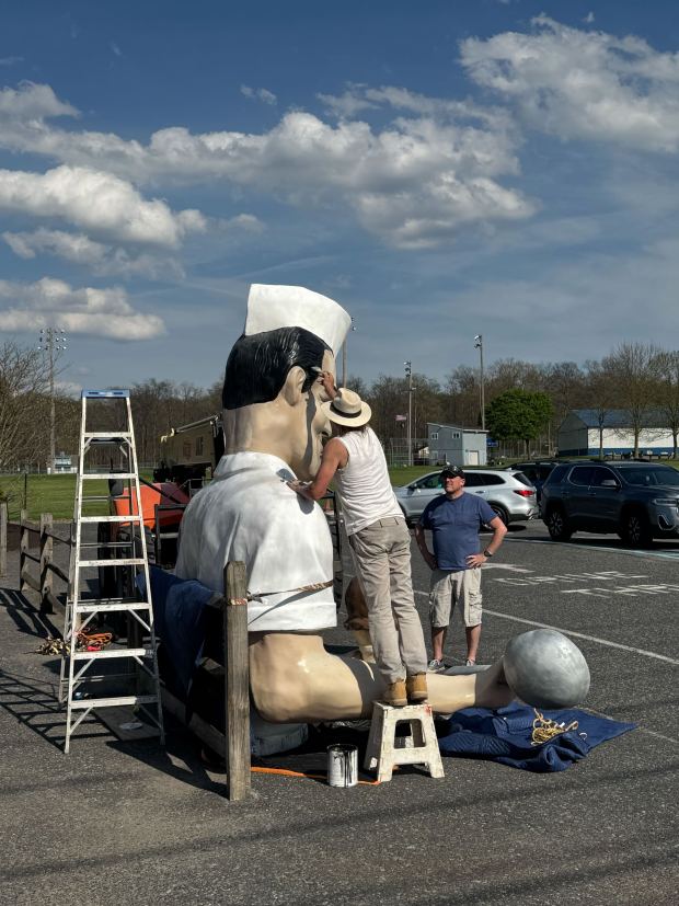 The repaired top half of Giant Chip sits outside Inside Scoop on Thursday, April 16, 2026, in Coopersburg. The popular, 25-foot-high statue was toppled by high winds in February. Roadside artist Mark Cline, who built the statue, was on site Thursday to repair it. (Graysen Golter / The Morning Call)