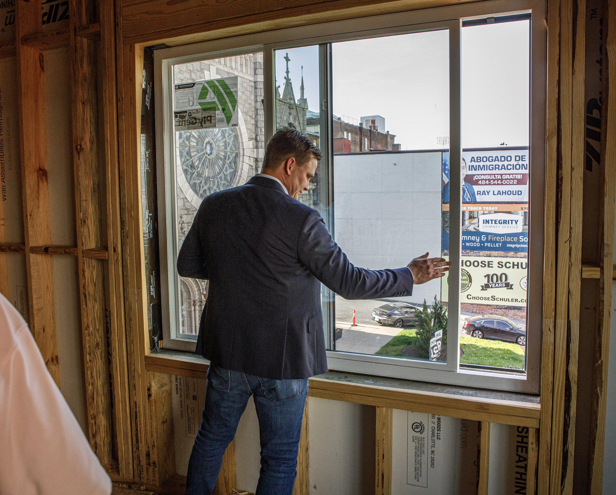 Jonathan Strauss of Cortex Residential opens a window during a...