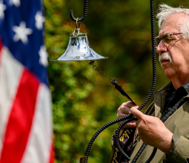 John Weiss rings the bell as the names of workers who have died are read Sunday, April 26, 2026, during the 35th annual Lehigh Valley Workers' Memorial Day ceremony in the Bethlehem Rose Garden. The ceremony remembered one of the area's bloodiest workplace tragedies, when when two gunmen walked into the First National Bank of Bath and shot five people June 6, 1986, killing three immediately, and a fourth who died years later. Three names will be added this year to the Lehigh Valley Workers' Memorial list, which includes roughly 4,400 workplace facilities since before the Civil War. Added this year are April Lubenetski, 51, who died May 19, 2025, after suffering from occupational cancer as a result of her employment as an Emmaus and Lehigh Township volunteer firefighter; Steven Gill, 36, who died May 21, 2025, when he was hit by an excavator in Weisenberg Township; and James Akins, 57, who died July 29, 2025, after suffering a medical event while installing solar panels on a roof in Allen Township.(April Gamiz/The Morning Call)