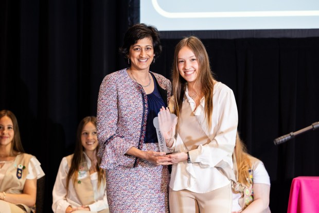 Radha Pyati, chancellor and dean of Penn State Berks, accepts an award from Girl Scout Kayla K. at Girl Scouts of Eastern Pennsylvania's annual Take the Lead event. Kayla K. shadowed Pyati for a day.(Courtesy of Girl Scouts of Eastern Pennsylvania.)