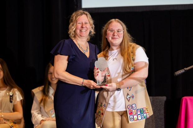 Honoree Meggan Hannigan, associate vice president of institutional advancement at Alvernia University, accepts an award from Girl Scout Shelby S. at the Girl Scouts of Eastern Pennsylvania's annual Take the Lead event. Shelby shadowed Hannigan for a day. (Courtesy of Girl Scouts of Eastern Pennsylvania.)