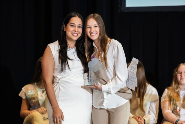 Monica Reyes, vice president for programs and initiatives at Berks County Community Foundation, accepts an award from Girl Scout Katelyn K. at Girl Scouts of Eastern Pennsylvania's annual Take the Lead event. Katelyn K. shadowed Reyes for a day.(Courtesy of Girl Scouts of Eastern Pennsylvania.)