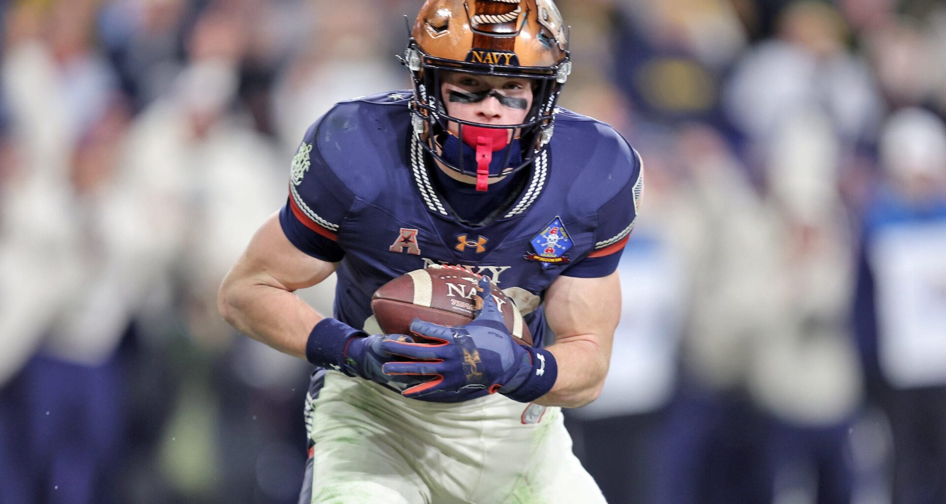 Dec 13, 2025; Baltimore, Maryland, USA; Navy Midshipmen slotback Eli Heidenreich (22) catches a pass for a touchdown against the Army Black Knights during the second half of the 126th Army-Navy game at M&T Bank Stadium