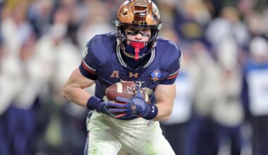 Dec 13, 2025; Baltimore, Maryland, USA; Navy Midshipmen slotback Eli Heidenreich (22) catches a pass for a touchdown against the Army Black Knights during the second half of the 126th Army-Navy game at M&T Bank Stadium