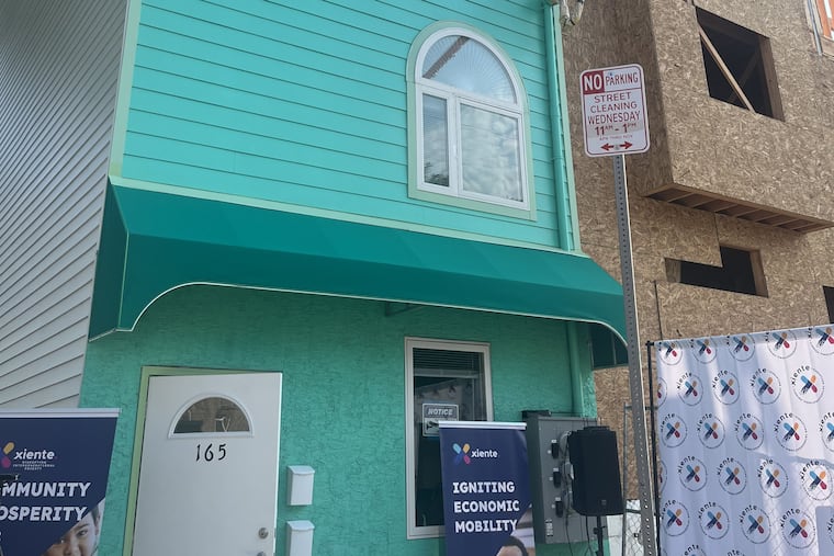 The teal home was developed in the first phase of nonprofit Xiente's Mi Casa project, which built 10 single-family rental homes for low-income families in the Norris Square neighborhood.