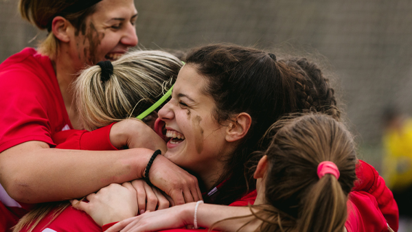 women sports players celebrating