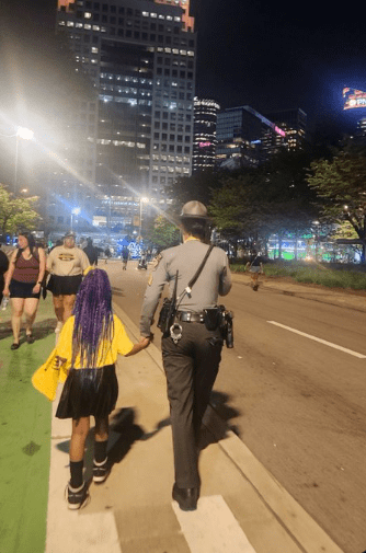 Pennsylvania State Police helping a young girl find her family after getting separated during the NFL Draft in Pittsburgh. Photo from PSP.