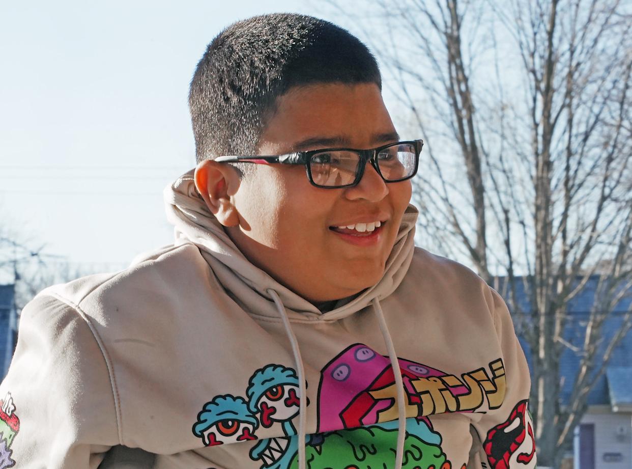 Edison Elementary School third-grade student Elijah Santiago-Rodriguez enters the new building for the first time, after Easter break and on crutches, in Erie, Pa.