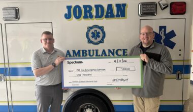 Michael Lane, Spectrum employee and volunteer, stands with Casey Brim, director of operations for Old Erie Emergency Services (right), after Old Erie Emergency Services received a $1,000 Spectrum Employee Community Grant. Lane nominated the organization for the grant, which will help purchase a new power loading system and stretcher for its ambulance. (Spectrum Photo)