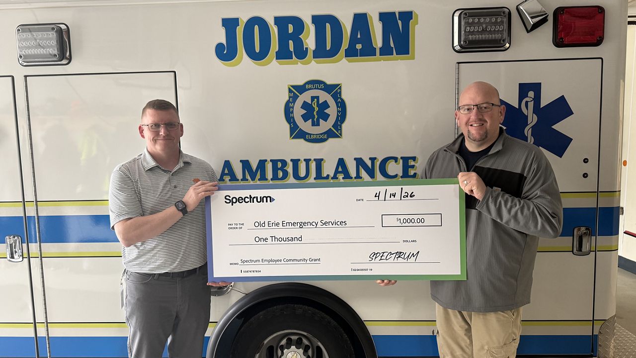 Michael Lane, Spectrum employee and volunteer, stands with Casey Brim, director of operations for Old Erie Emergency Services (right), after Old Erie Emergency Services received a $1,000 Spectrum Employee Community Grant. Lane nominated the organization for the grant, which will help purchase a new power loading system and stretcher for its ambulance. (Spectrum Photo)