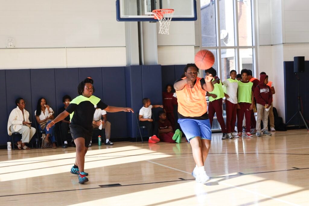 A student passes the ball up the court during the basketball game.