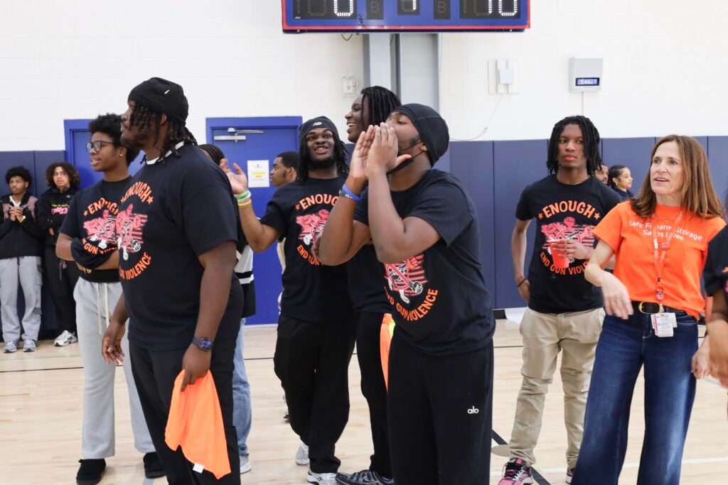 A group of students cheering on the basketball players.