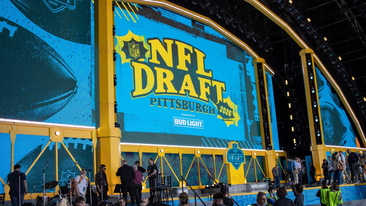 Side profile view of the NFL Draft stage with Fort Pitt Bridge backdrop outside Acrisure Stadium