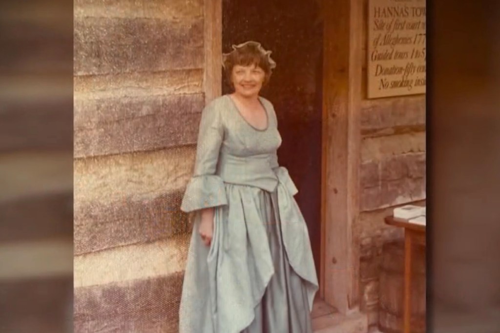 Peggy Fields smiling in a period costume at Hanna's Town.