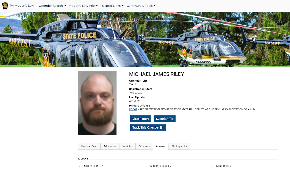 Mugshot of a bald man with a beard on a webpage featuring police helicopters and offender information under the name Michael James Riley.