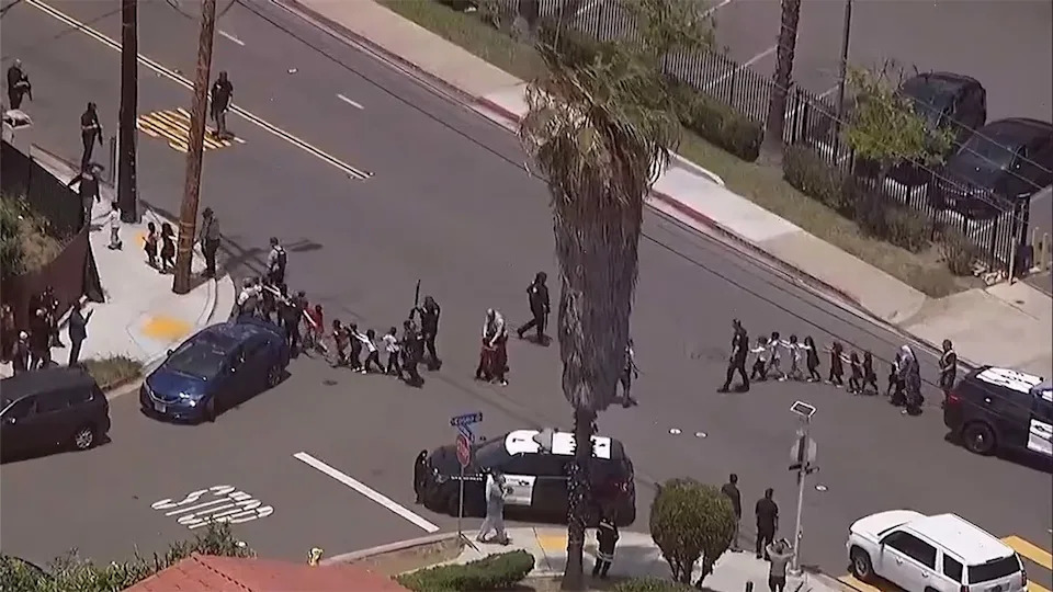 People are led away by police from the Islamic Center of San Diego, May 18, 2026. KGTV
