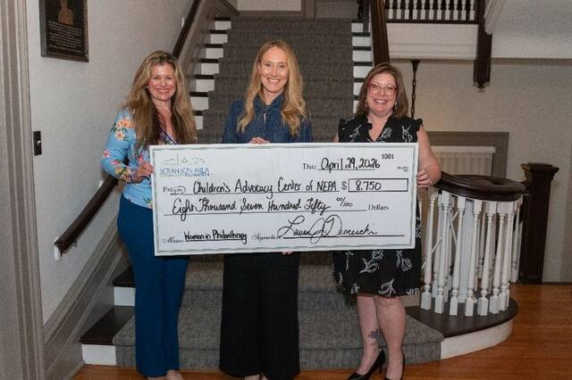 <p>Laura Ducceschi, president and CEO of Scranton Area Community Foundation; Megan Gagorik, director of Children’s Advocacy Center; and Amy Betts, lead community impact manager of Scranton Area Community Foundation, hold the check to the Children’s Advocacy Center.</p>
<p>Submitted photo</p>