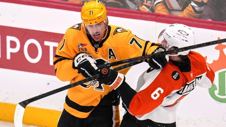 Pittsburgh Penguins' Evgeni Malkin (71) is defended by Philadelphia Flyers'...
