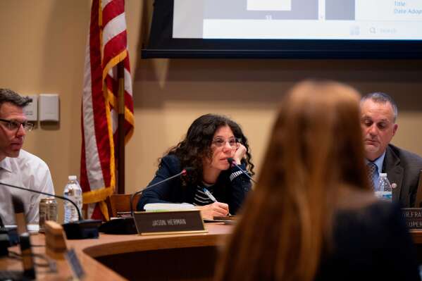 Members of the Lower Merion Board of School Directors speak with attendees at a school board meeting on Monday, May 11, 2026, in Ardmore, Pa. (AP Photo/Joe Lamberti)