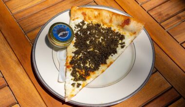 A $55 caviar pizza slice is served on a gold plate at a Philadelphia pizza shop