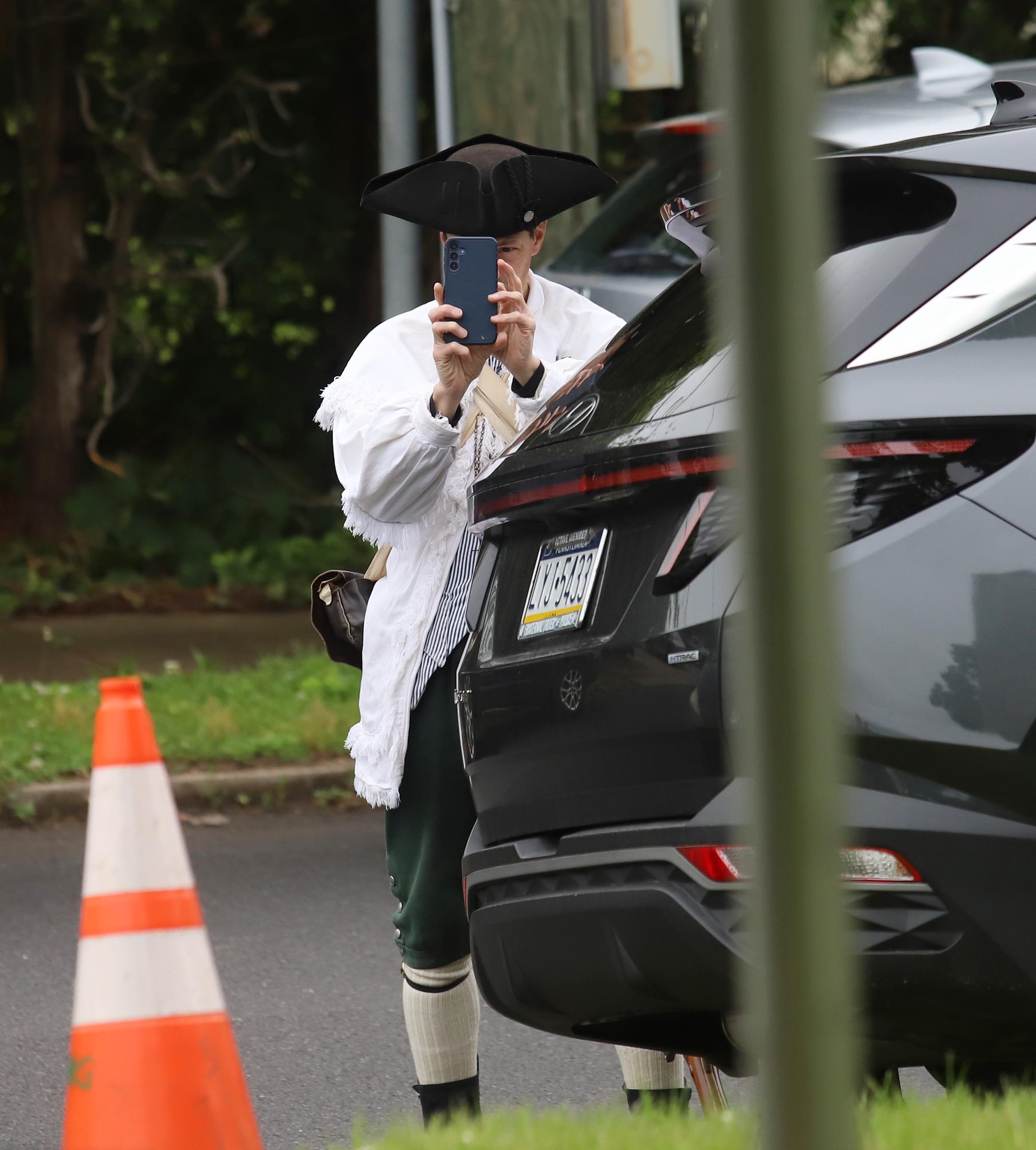 A renactor takes a cell phone picture during a Memorial...