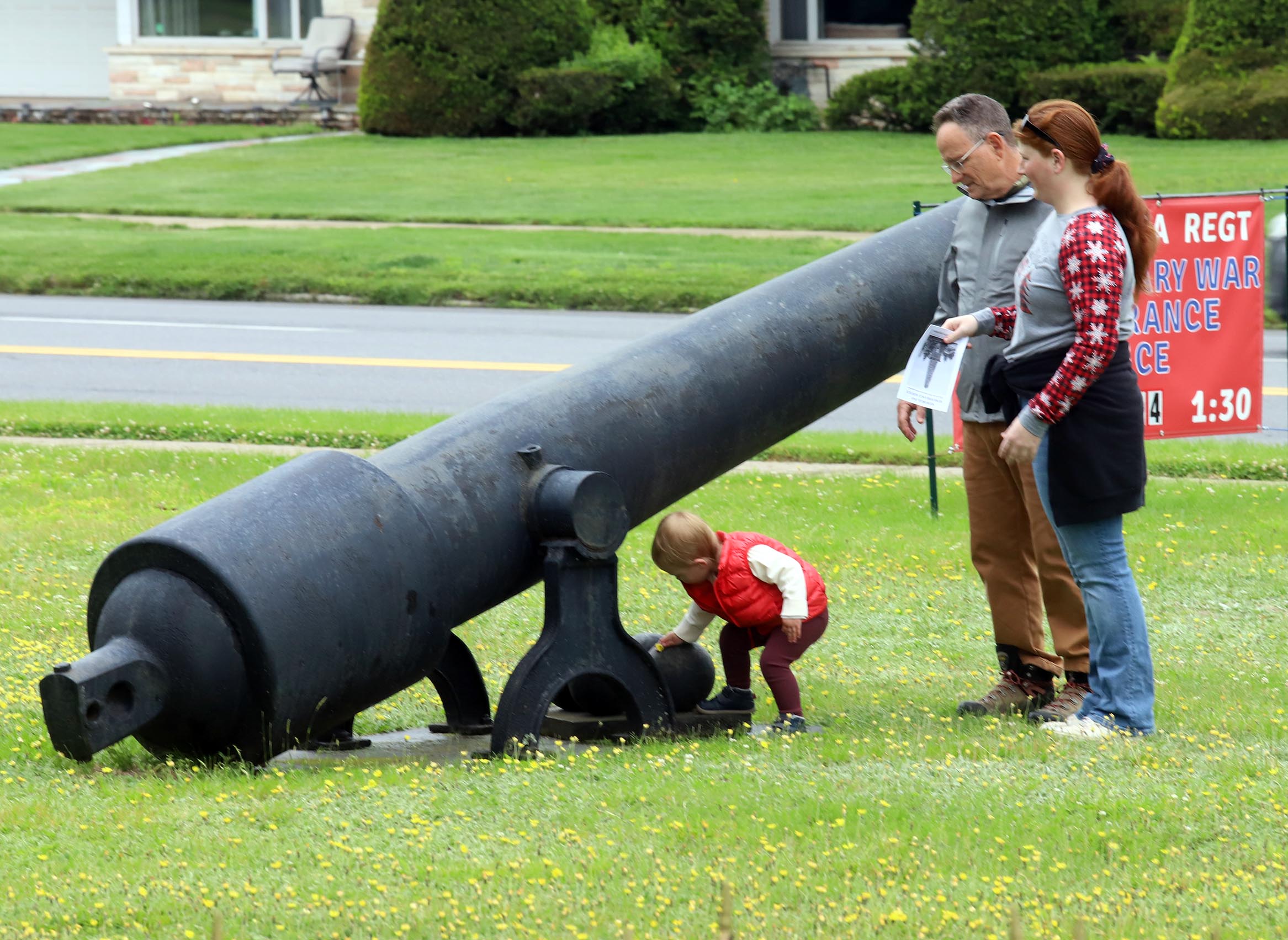 Charles, Sofia, and Livia McCluskey look over a cannon during...