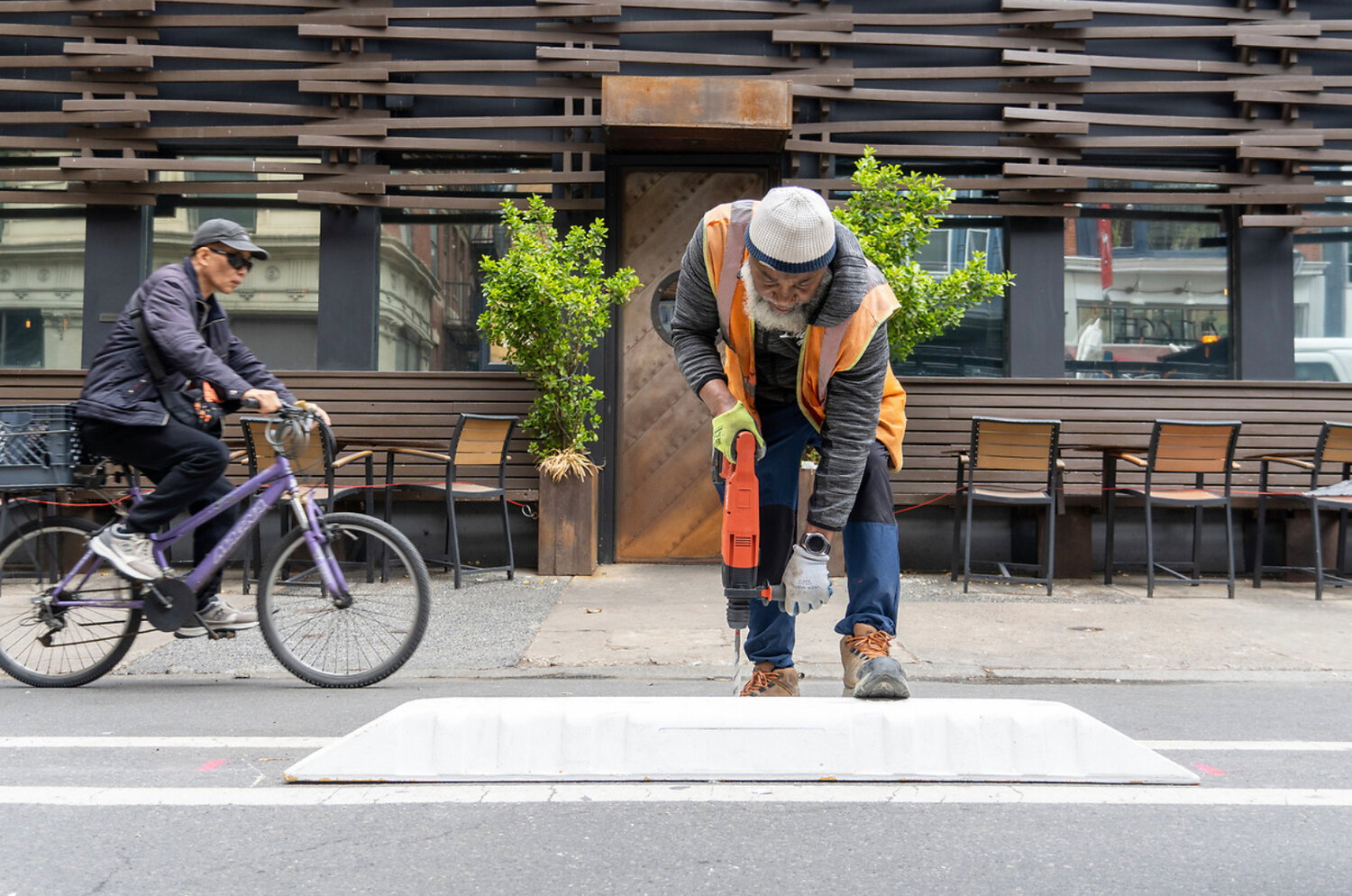 The Streets Department of Transportation install modular plastic curbs between Locust and Chestnut streets.