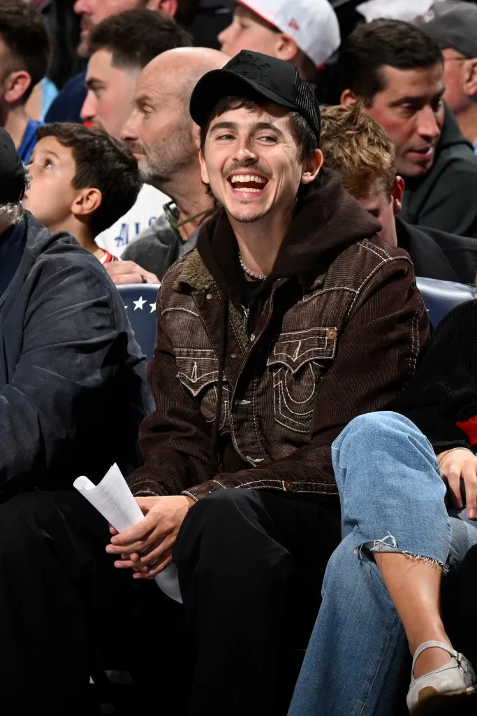 Timothee Chalamet smiles during the game during Round 2 Game <br>3 of the 2026 NBA Playoffs on May 8, 2026 at the Wells Fargo <br>Center in Philadelphia on May 8, 2026. NBAE via Getty Images