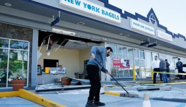 New York Bagels employee Tareq Kayyali sweeps glass from the parking lot after an explosion at the beloved Overbrook Park kosher bagel shop, along the 7500 block of Haverford Ave., on Sunday, May 10, 2026.