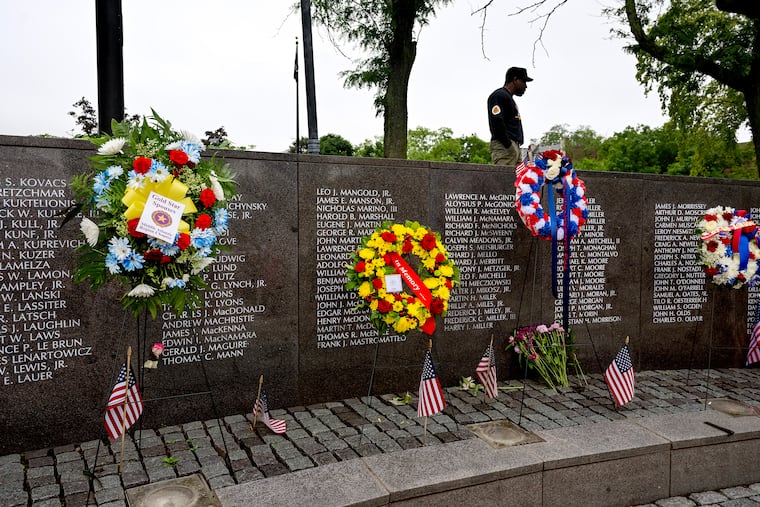 Jay Adams looks over the wall of names following the Memorial Day service at the Philadelphia Vietnam Veterans Memorial. He wears an MIA T-shirt honoring his wife’s uncle, Carlos Ashlock, who was one of nine men from Philadelphia who went Missing in Action during the Vietnam War. Ashlock was 21 when he went missing in 1967 after a days long combat.