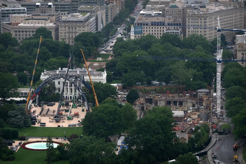 Equipment for a future UFC fight is being placed on the South Lawn in front of the White House, Tuesday, May 26, 2026, in Washington, as work continues on the construction of the ballroom, right, as seen from the Washington Monument. (AP Photo/Mark Schiefelbein)