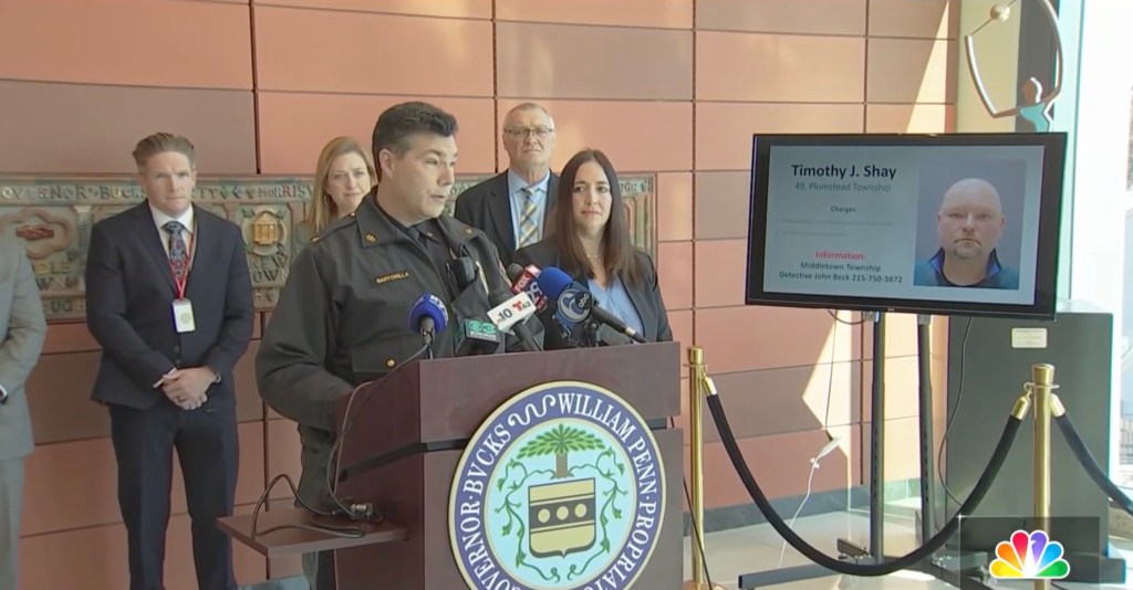 A press conference with law enforcement officials, a screen displaying information about Timothy J. Shay and his mugshot.