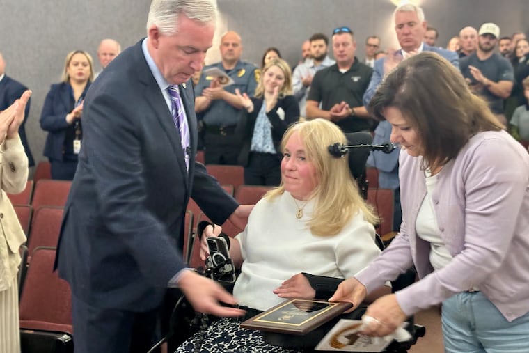 Bernadette Gaudio accepts an award posthumously granted to her son Andrew from Montgomery County District Attorney Kevin Steele.