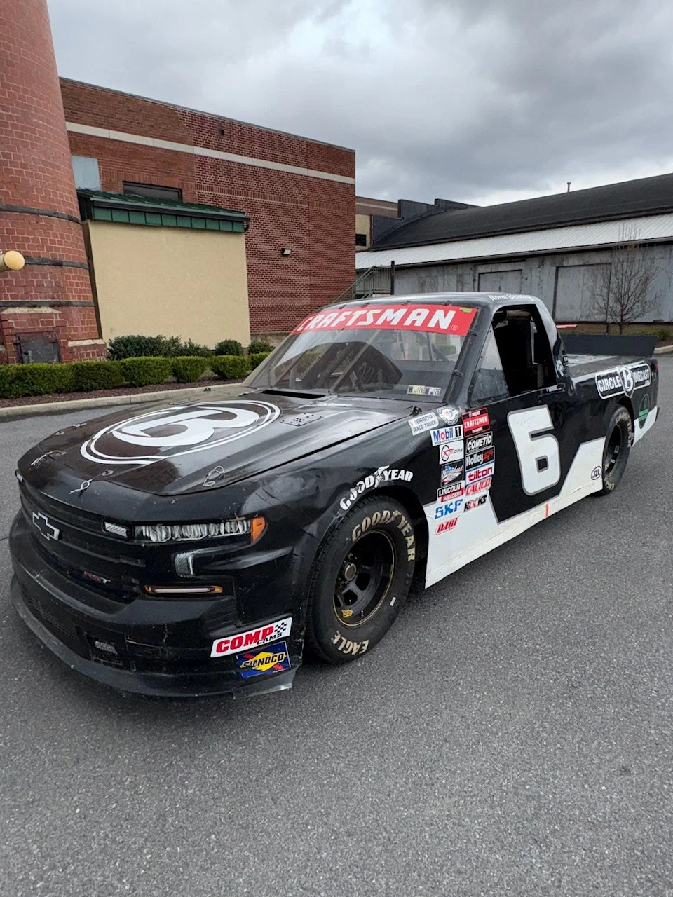 a racing truck parked outside a building