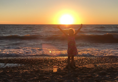 child on lake erie shore at sunset in erie pa