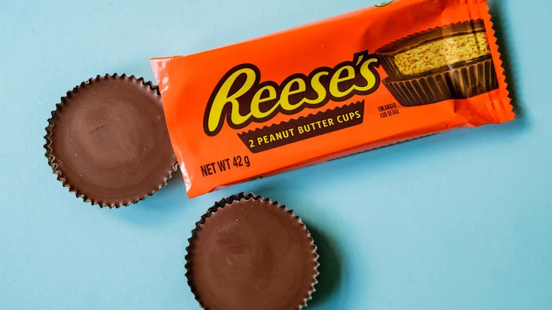 An opened package of Reese's on a blue surface