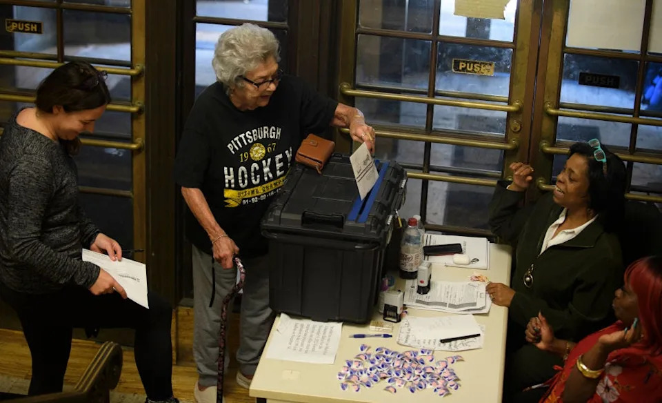 Voters cast mail-in ballots at the Board of Elections office in the Allegheny County Office Building in Pittsburgh.