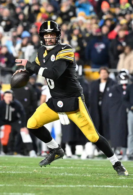 Jan 12, 2026; Pittsburgh, PA, USA; Pittsburgh Steelers quarterback Aaron Rodgers (8) scrambles during the first half of an AFC Wild Card Round game against the Houston Texans at Acrisure Stadium. Mandatory Credit: Barry Reeger-Imagn Images