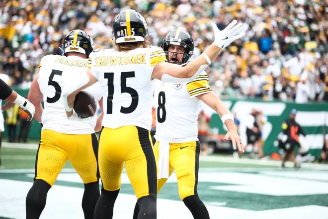 Sep 7, 2025; East Rutherford, New Jersey, USA; Pittsburgh Steelers quarterback Aaron Rodgers (8) celebrates a touchdown scored by wide receiver Ben Skowronek (15) in the first quarter at MetLife Stadium. Mandatory Credit: Wendell Cruz-Imagn Images
